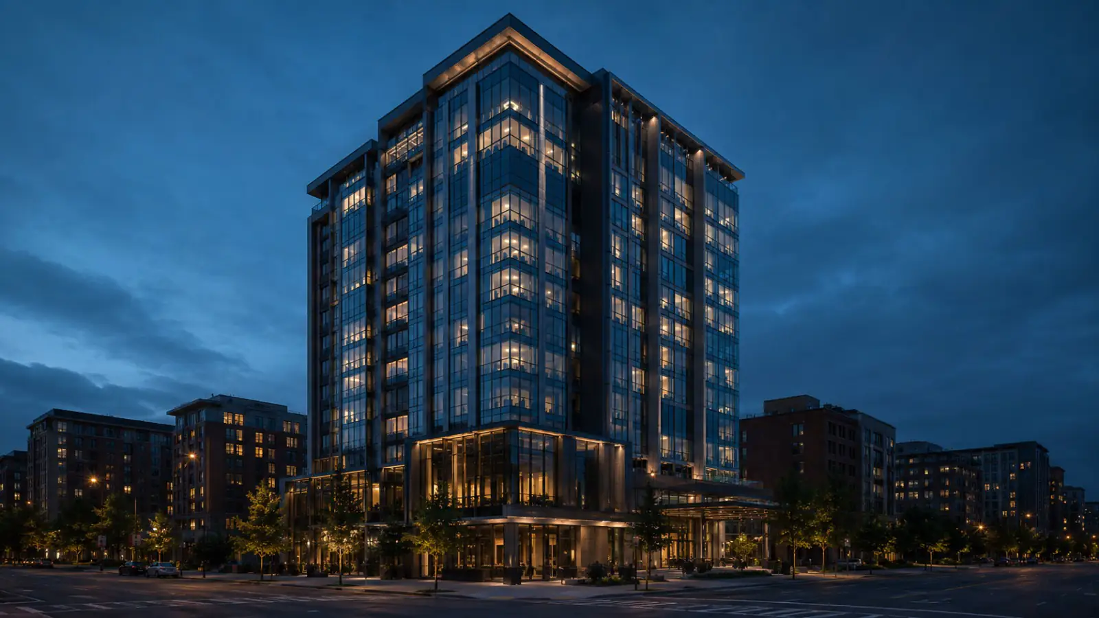 A hotel building at blue hour with guest-room windows lit